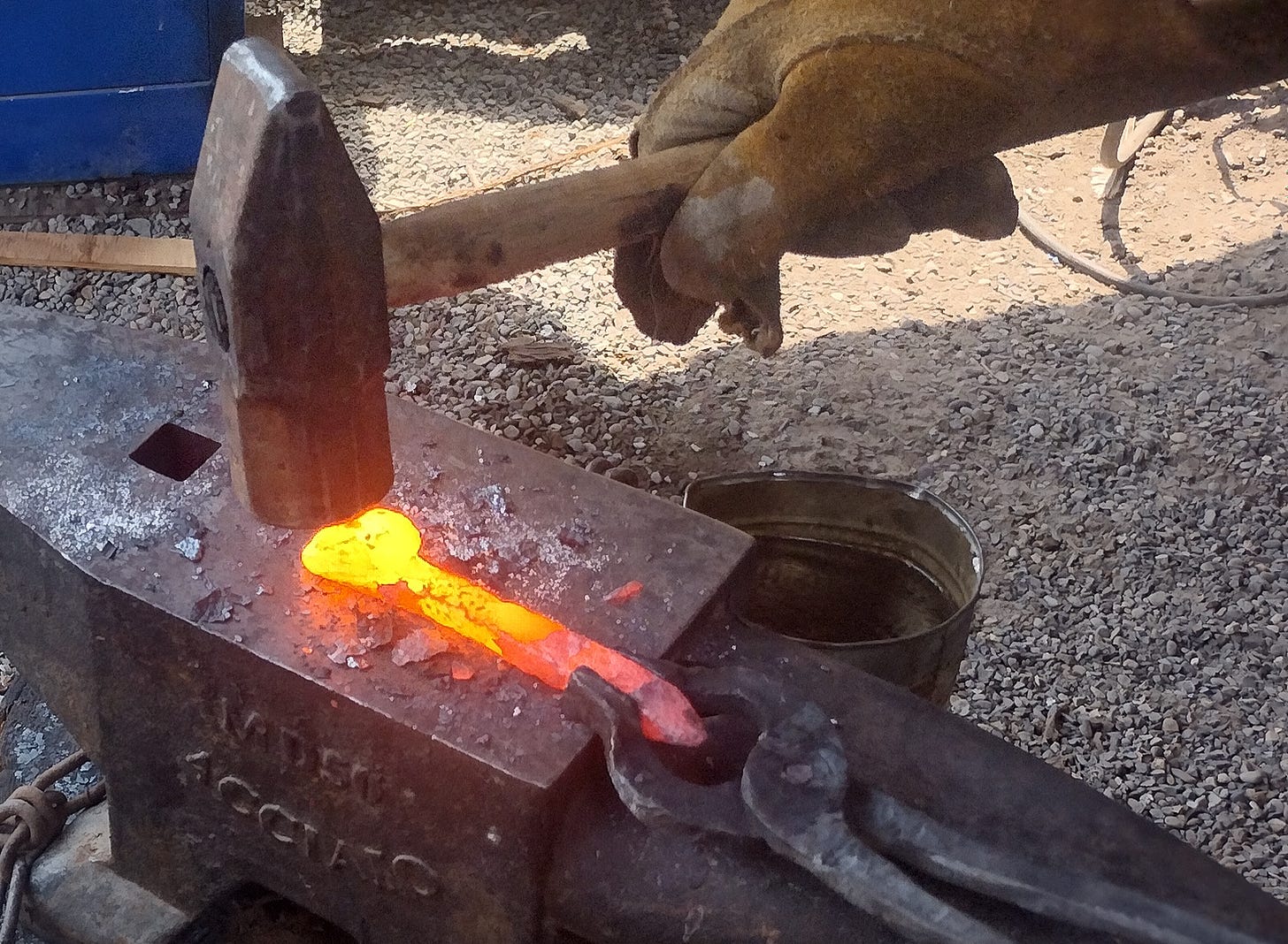 3lb hammer tapping on yellow steel to set the weld.