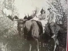 Sitting on a moose at Alaska's Chugiak fair in 1957.