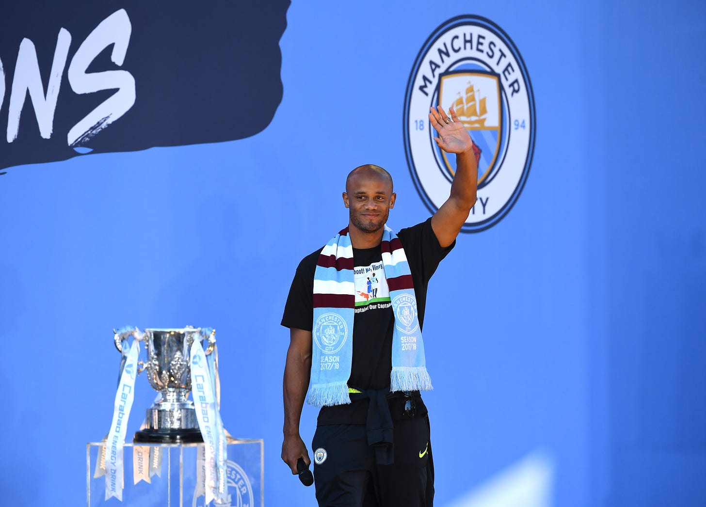 Vincent Kompany pictured waving to fans at a Manchester City trophy parade in May 2019