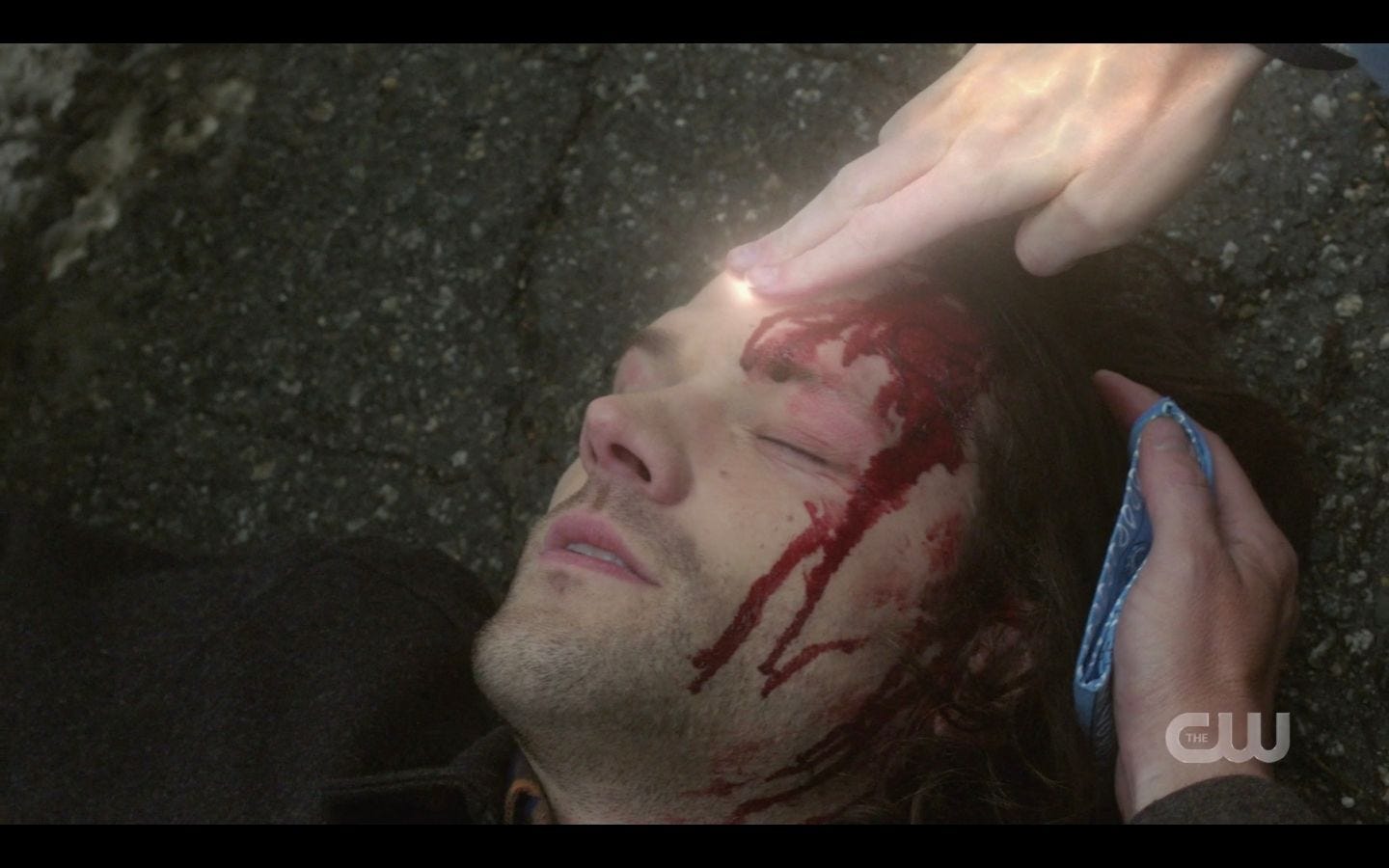 Dean Winchester holding cloth to Sams bloody head SPN 14.17