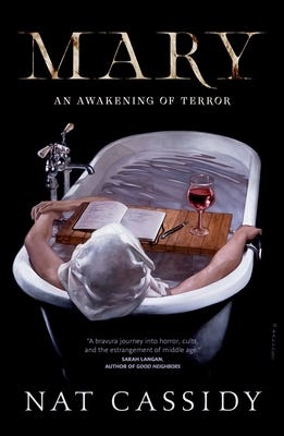 The book cover for MARY: An Awakening of Terror by Nat Cassidy. Cover is mostly black with a white freestanding bath tub in an almost top-down view. A woman lounges in the tub, her back to us, arms resting on the sides, a white cloth over her head and a third arm reaching out of the water to grasp one of her hands