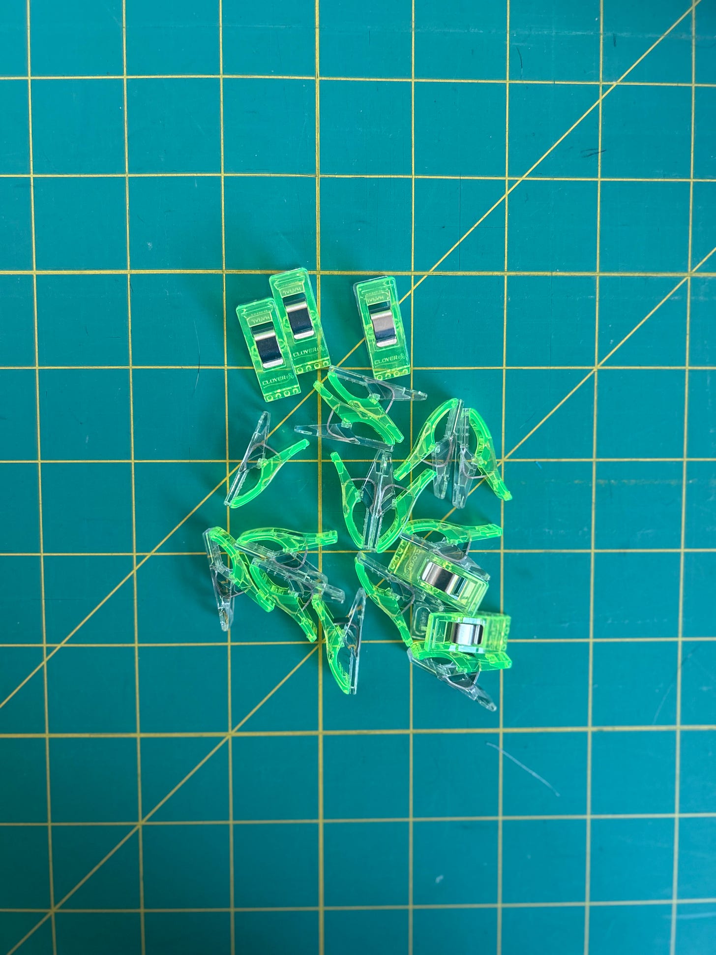 Lime green wonder clips on a green background