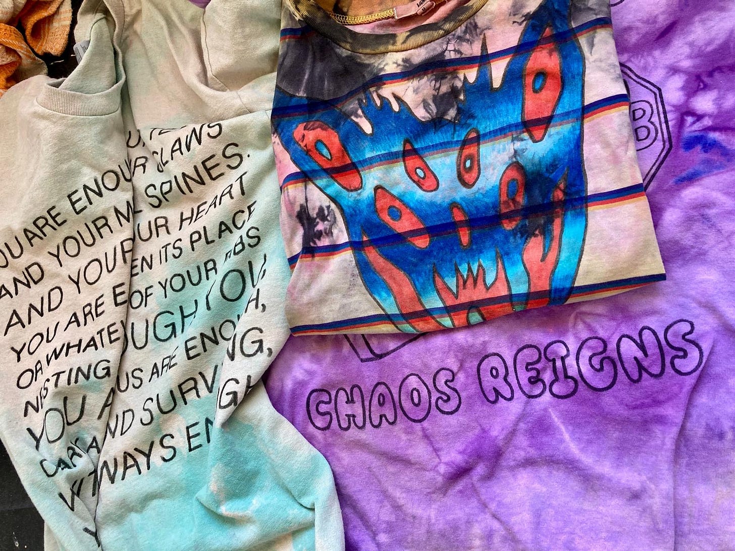 "Chaos reigns" written on tie die shirt