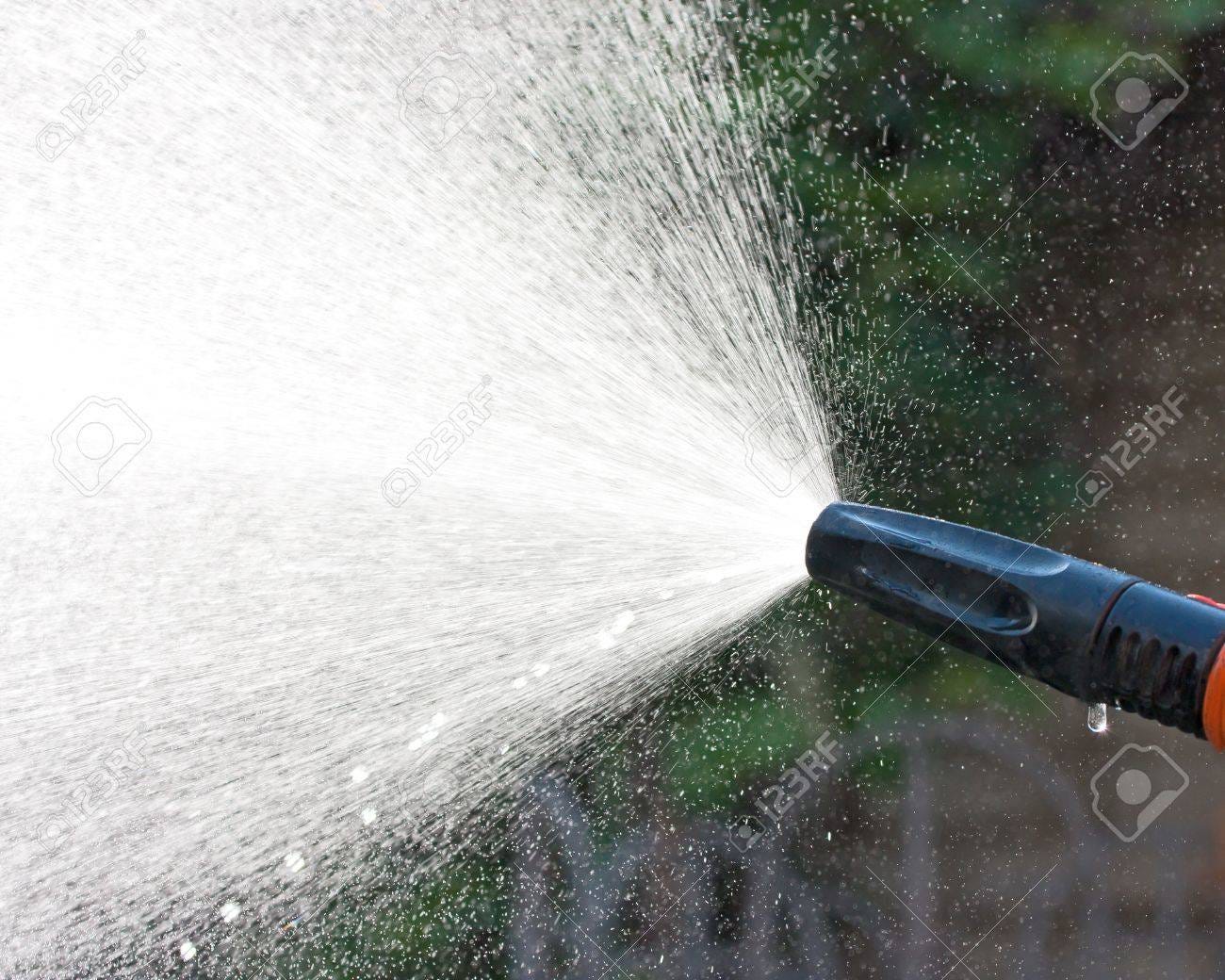 Water Spraying From A Garden Hose Stock Photo, Picture and Royalty Free  Image. Image 15165030.