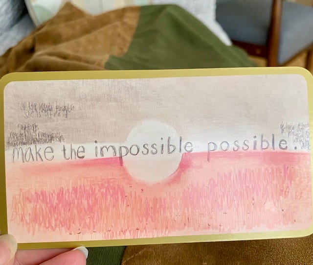 Photo of a card that reads: Make the impossible possible.