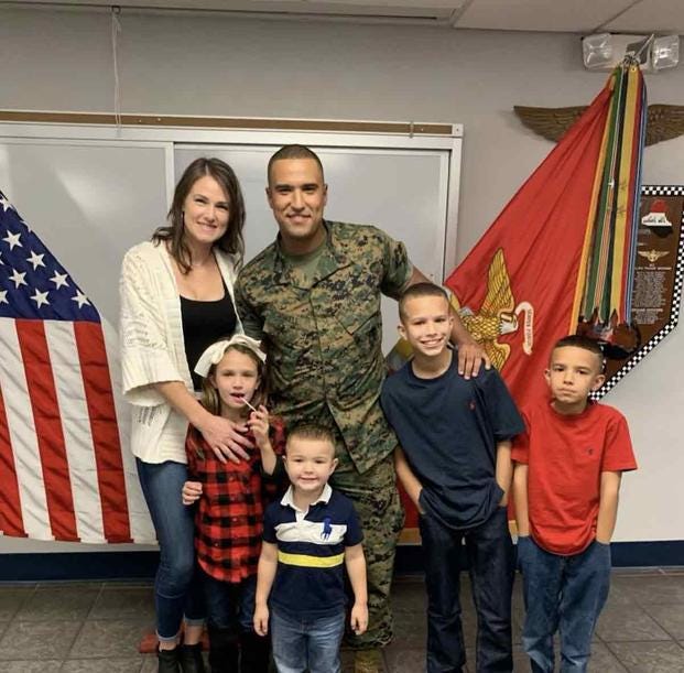 Newly promoted Gunnery Sgt. Logan Sowell stands for a photo with his family