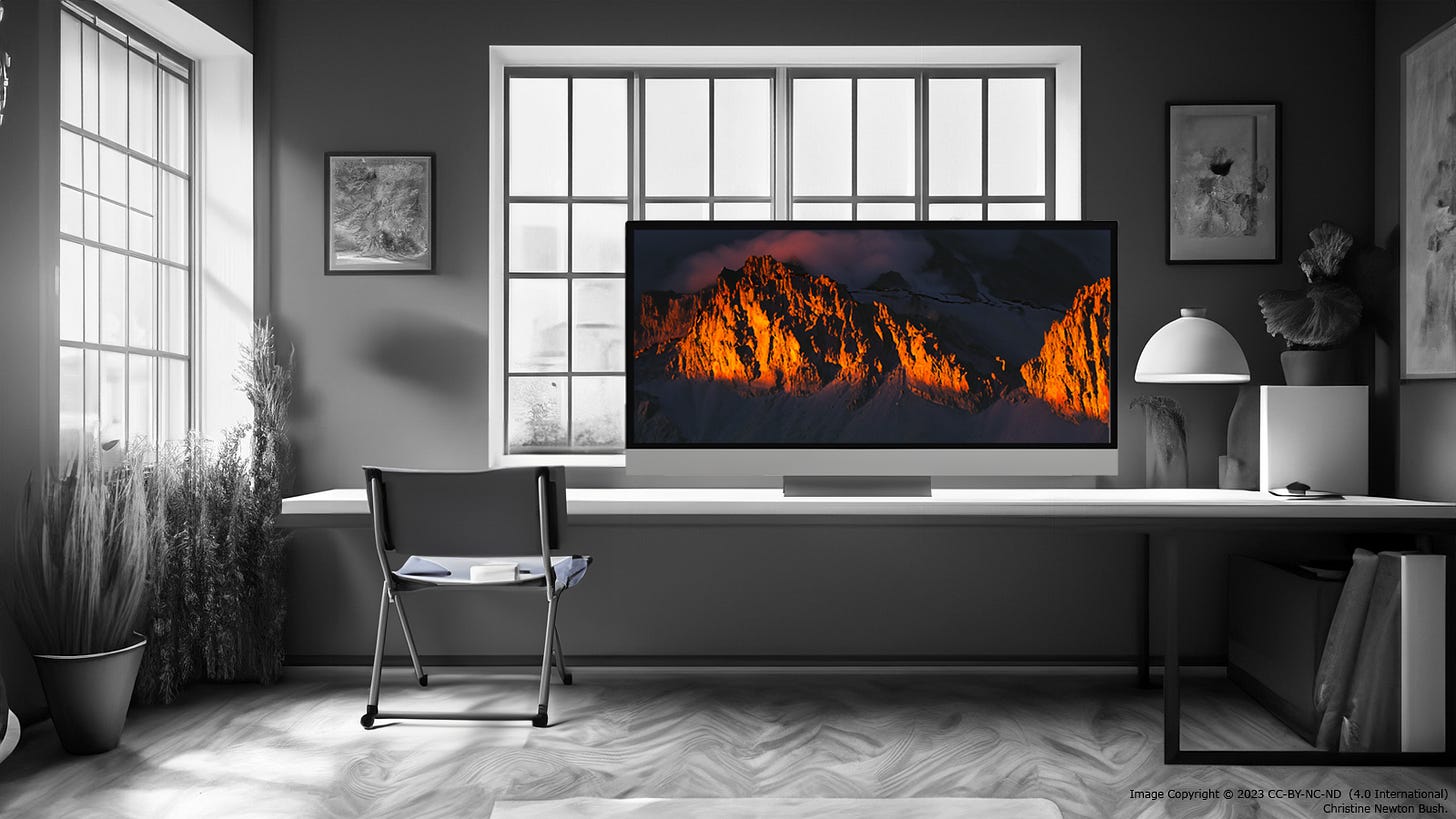 Image of a surreal grayscale office with desk upon which sits a computer displaying a full color image of dramatically lit mountain tops with clouds and mist.