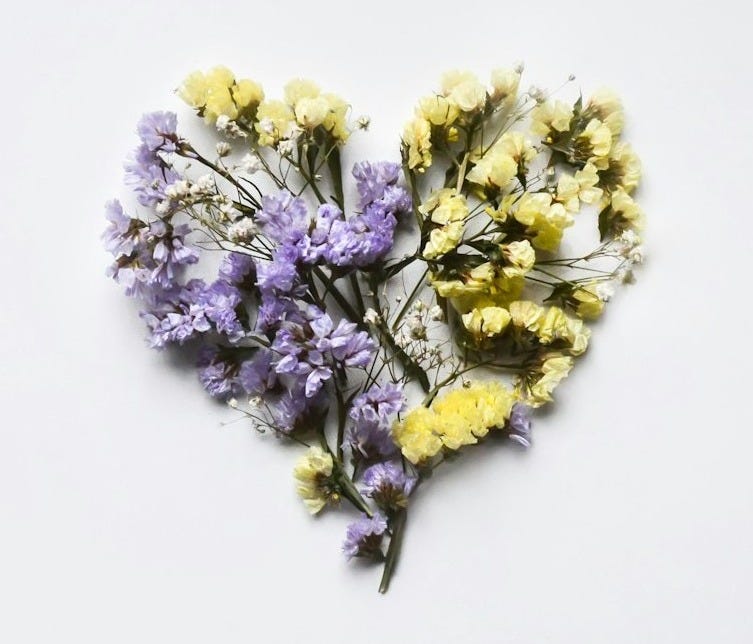 dried flowers arranged in the shape of a heart