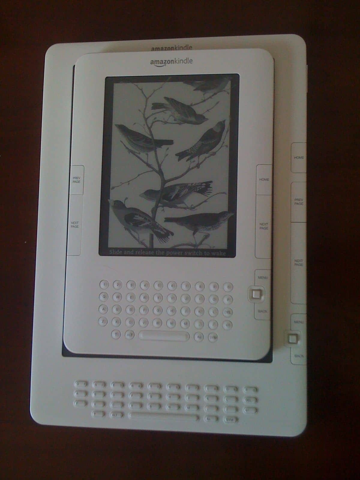 The Kindle DX with a Kindle 2 covering its screen