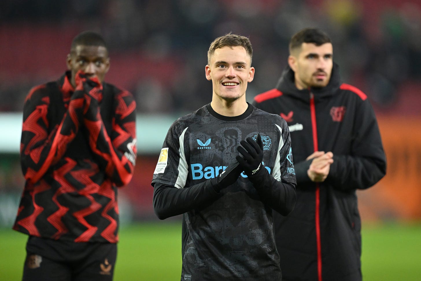 Florian Wirtz smiles after Leverkusen clash with FC Augsburg in the Bundesliga.