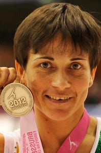 A person holding a medal

Description automatically generated