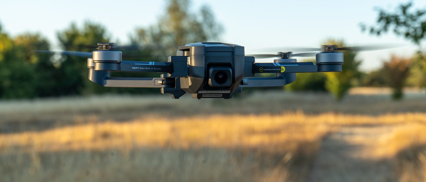 Holy Stone HS720E drone capturing a panoramic view of a cityscape