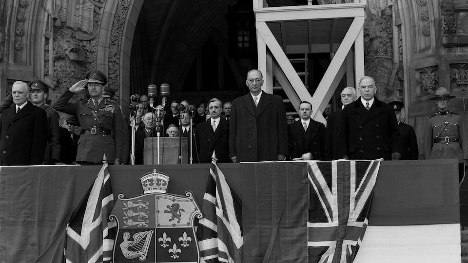 Archive photo showing Canadian Prime Minister Louis St-Laurent, Canada's new Secretary of State, F. Gordon Bradley of Newfoundland, and former Canadian Prime Minister William Lyon Mackenzie King in front of the Canadian Parliament.