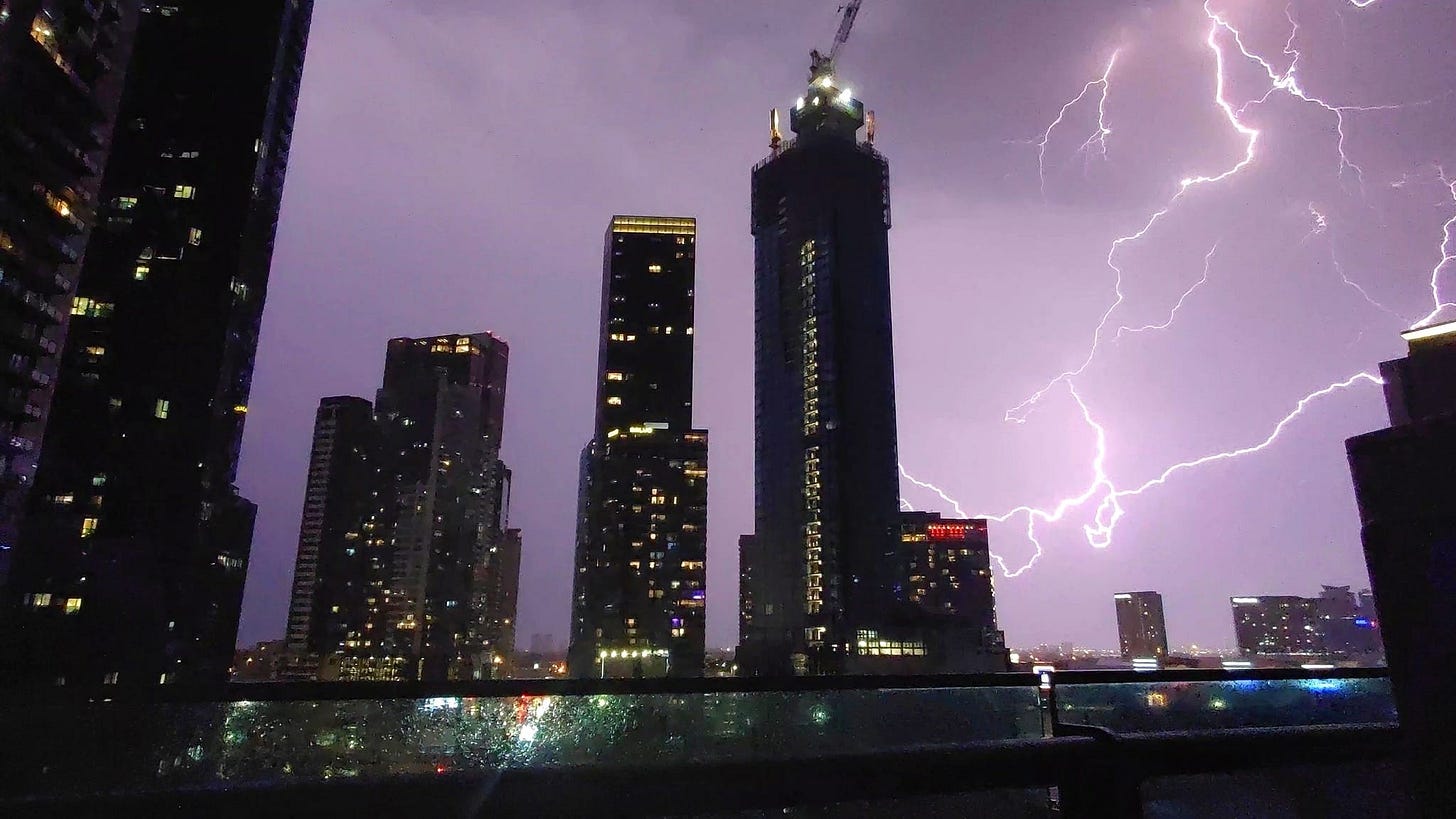 May be an image of skyscraper and lightning