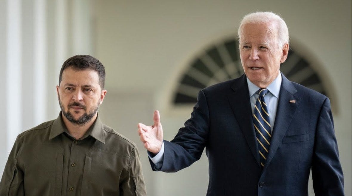 Volodomyr Zelensky walks alongside Joe Biden