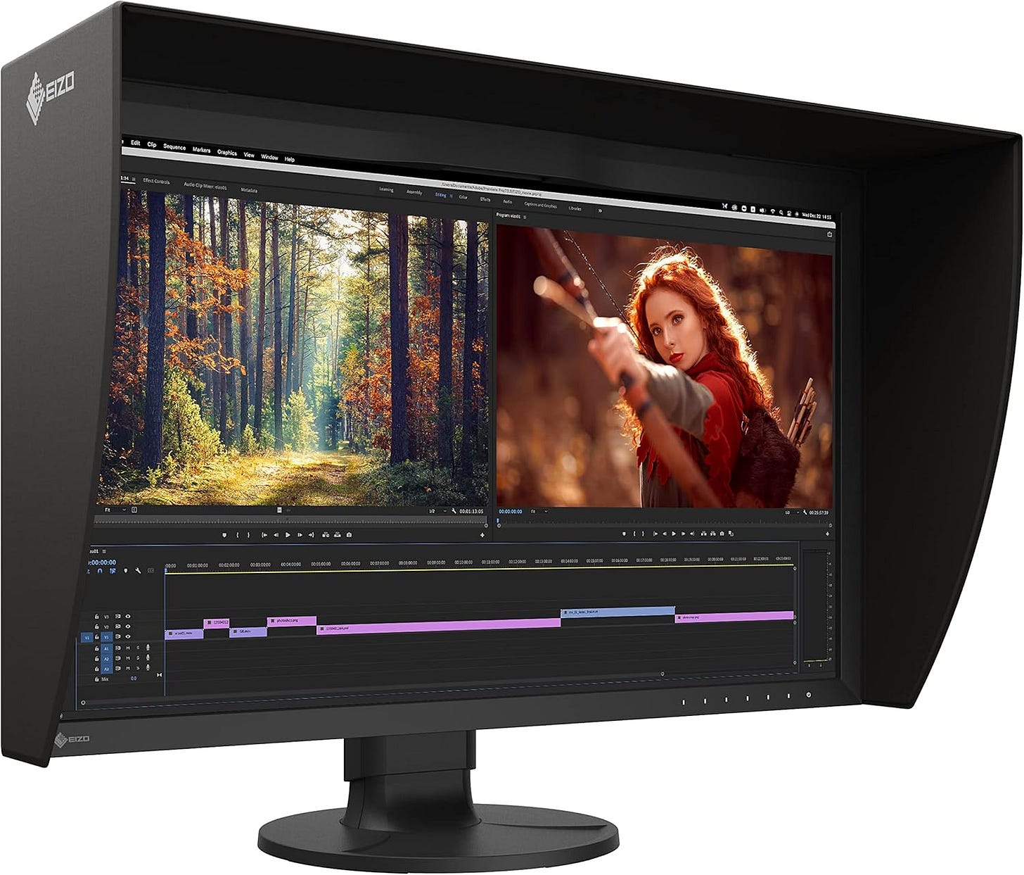 An Eizo ColorEdge CG2700X professional monitor displaying a photo editing interface with two images in Adobe Premiere Pro - a forest scene with autumn colors and sunlight streaming through trees on the left, and a costumed archer character on the right. The monitor features distinctive black hood shields and the Eizo logo, showcasing its professional-grade design for color-critical work. The timeline below shows several colored editing tracks, and the monitor's sleek black design includes a sturdy adjustable stand.