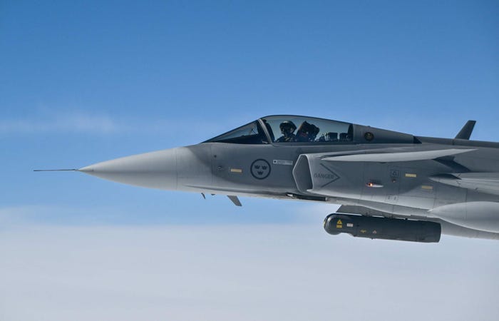 The front half of a Swedish Air Force Saab JAS 39 Gripen jetfighter in the air.