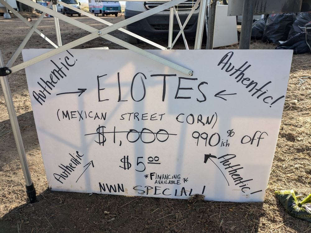 a hand-written sign advertising ELOTE (Mexican Sweet Corn) for $1,000, marked down to $5, haha