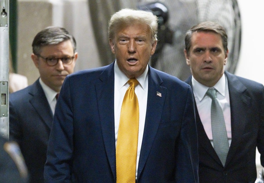 NEW YORK, NEW YORK - MAY 14: Former US President Donald Trump (C) with the US Speaker of the House Mike Johnson (L) and his attorney Todd Blanche as he arrives for his trial for allegedly covering up hush money payments linked to an extramarital affair with Stormy Daniels, at Manhattan Criminal Court on May 14, 2024 in New York City. Former U.S. President Donald Trump faces 34 felony counts of falsifying business records in the first of his criminal cases to go to trial. (Photo by Justin Lane - Pool/Getty Images)