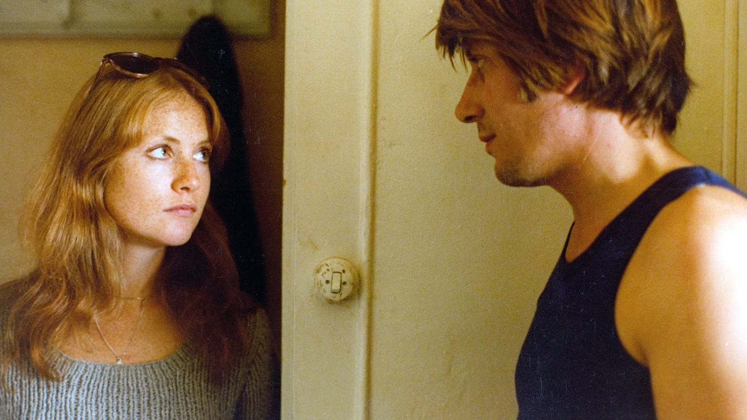 A still from Every Man for Himself featuring Isabelle Huppert looking directly at Jacques Dutronc.