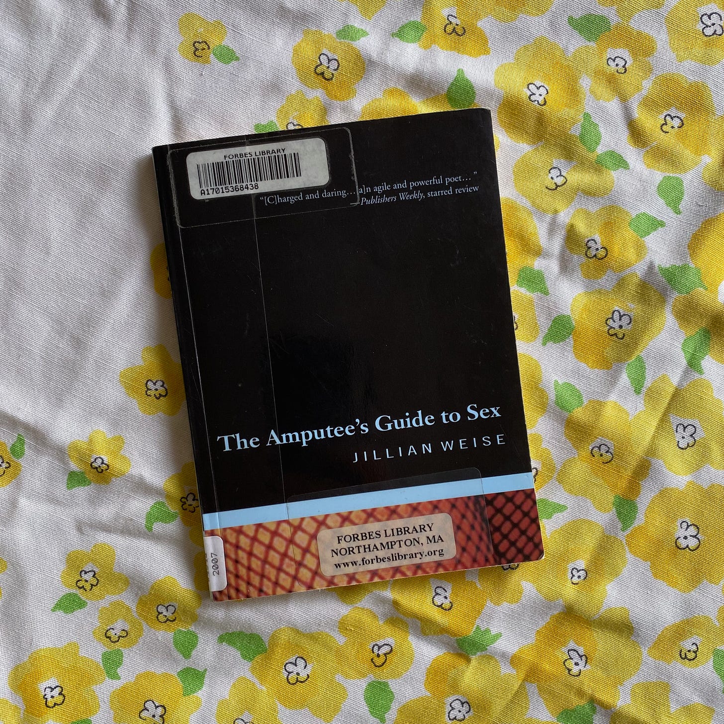 This book on a tablecloth patterned with yellow flowers.