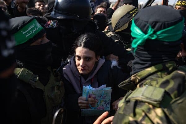 Arbel Yehud holds a small bag amid a thick crowd of people.