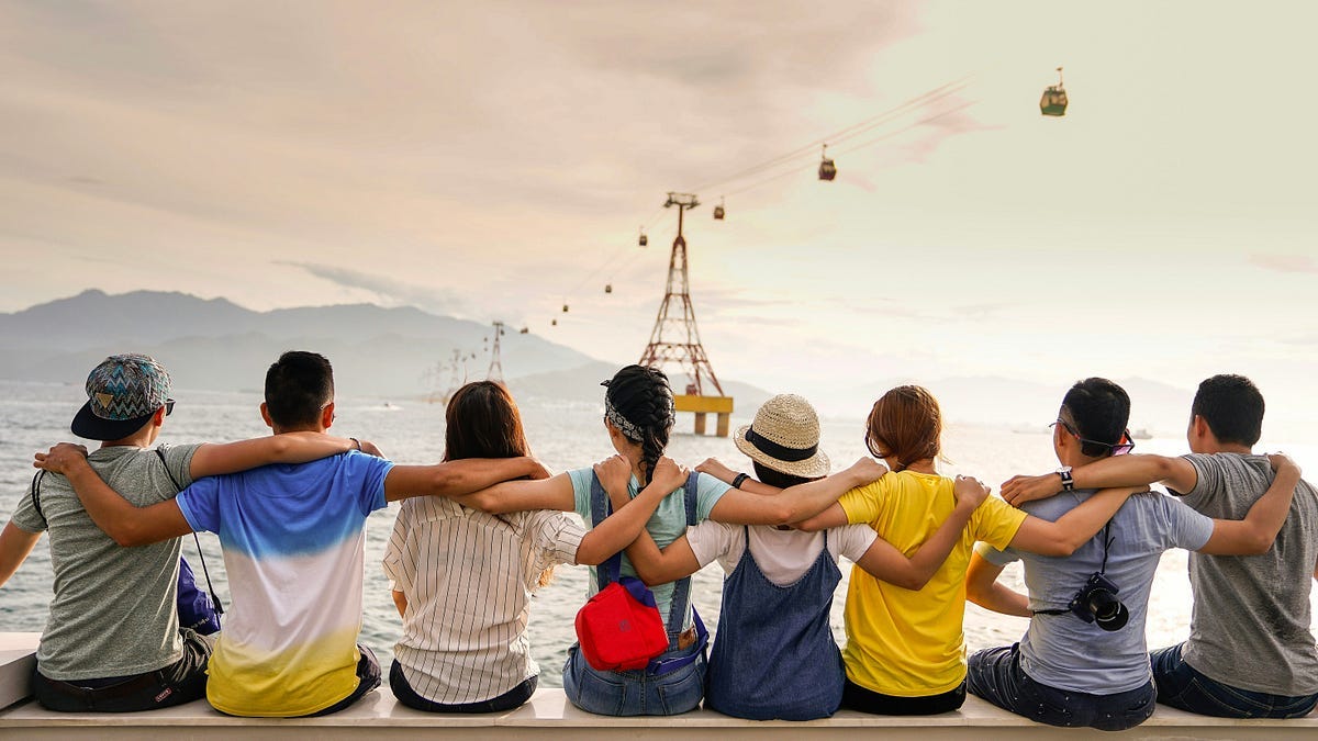 Friends sitting and looking out to sea.
