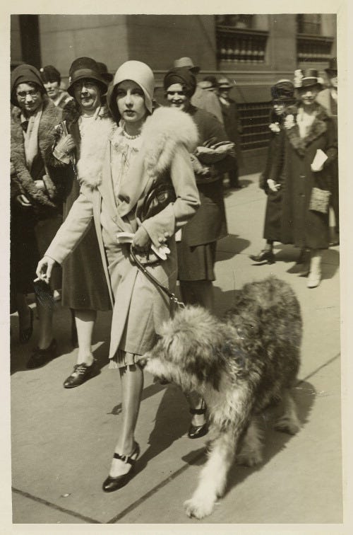 At the 1929 Easter Parade, New York City. She holds a cigarette.