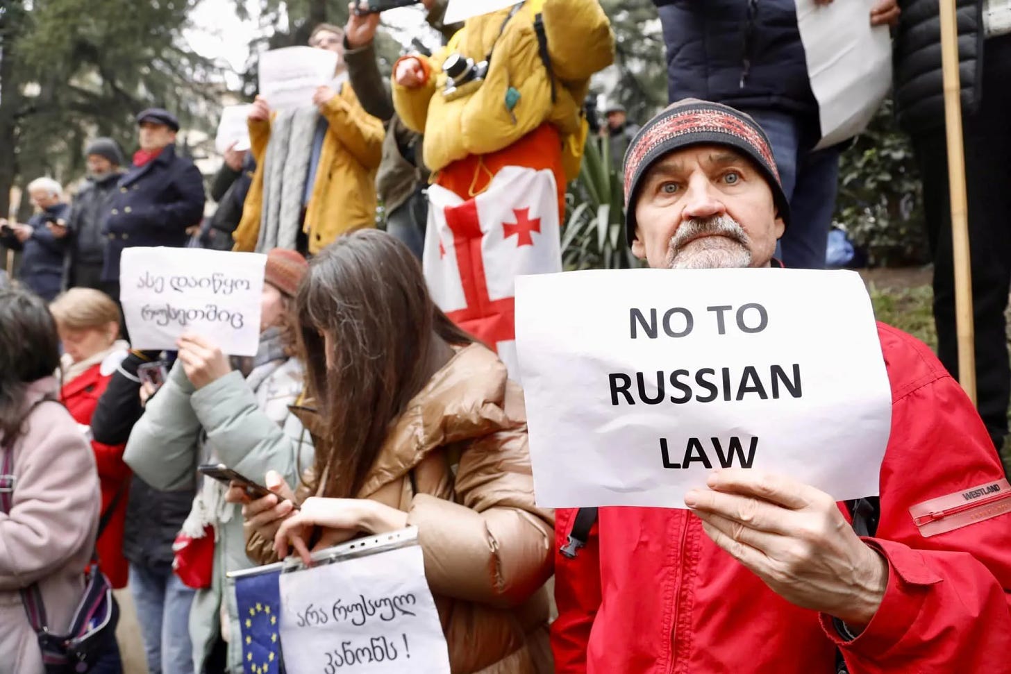 A protest against the "Russian Law". One sign says "No to Russian Law" in English, one says the same in Georgian, and one says "This is also how it started in Russia" in Georgian.