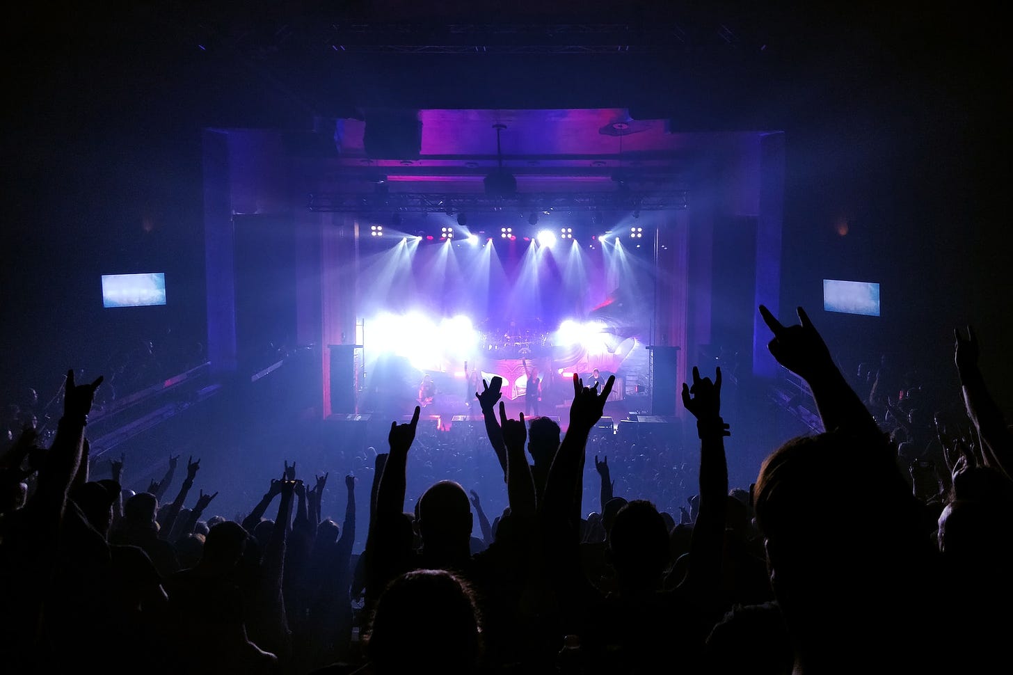 concert photo crowd cheering artisits on stage