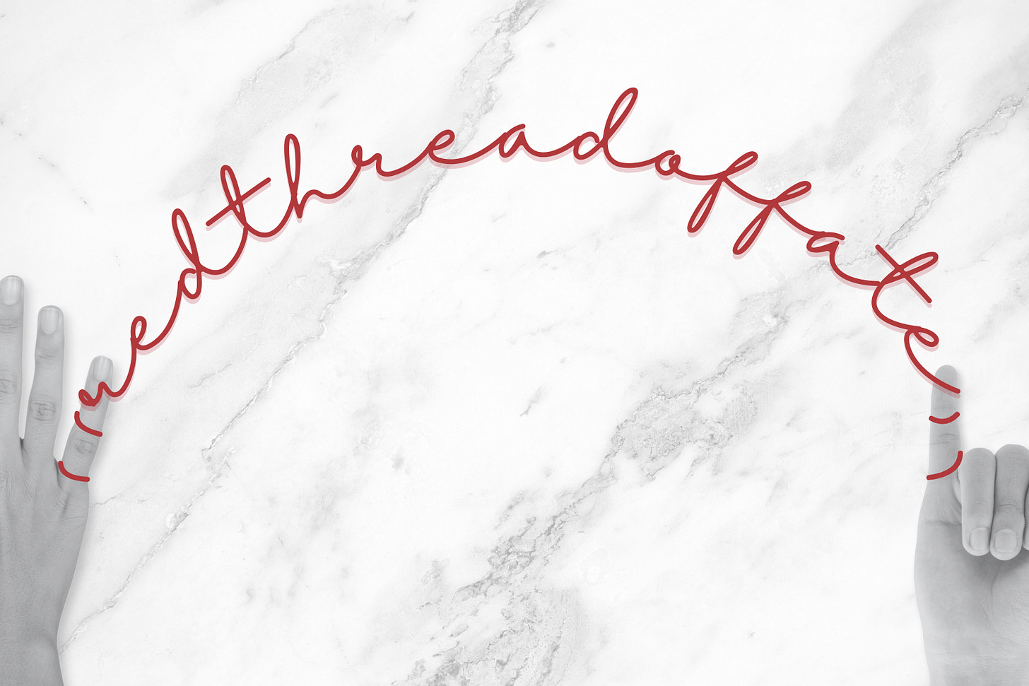 Two hands are tied together with a red thread that connects to the little finger of each hand, forming the phrase "red thread of fate" against a white marble background.