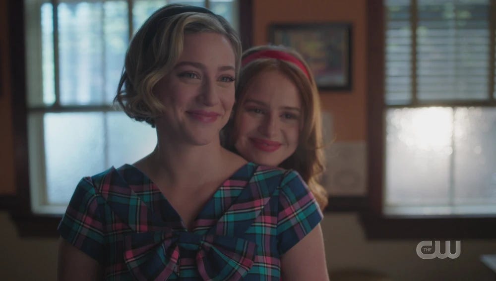 Betty smiling and Cheryl standing behind her smiling as well.