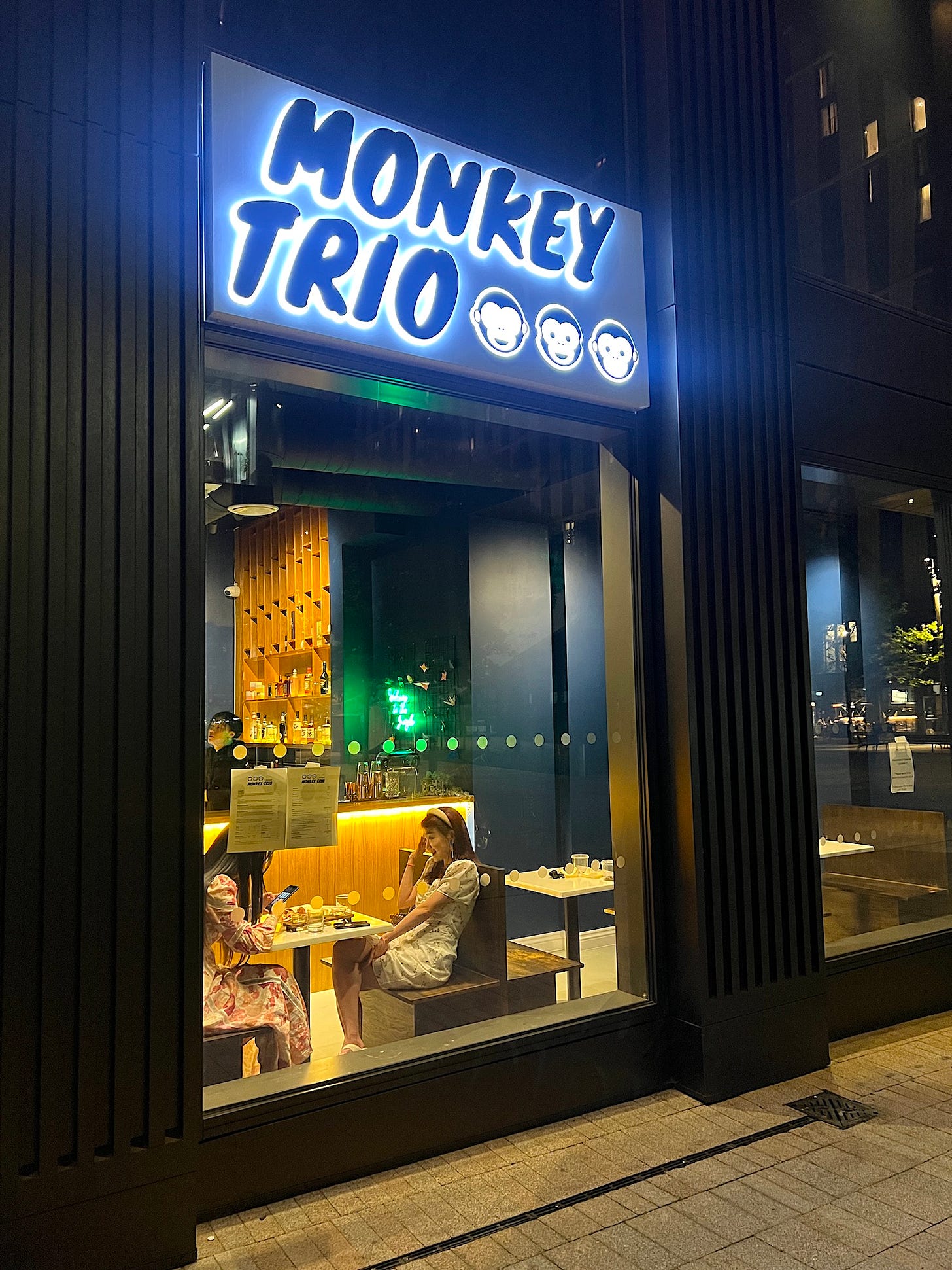 two women sit in a window booth at the newly opened monkey trio japanese pub manchester