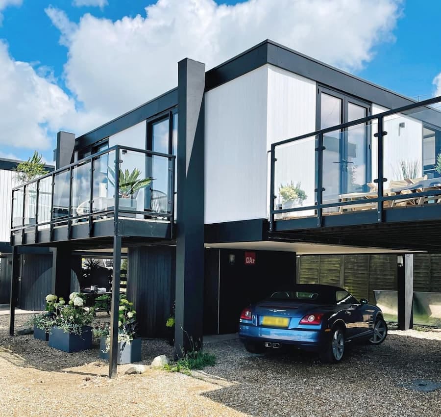 A monochromatic 1960s deckhouse on stilts