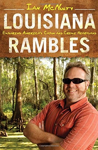 Book jacket of Louisiana Rambles. The author is standing cross-armed and smiling against a bayou backdrop
