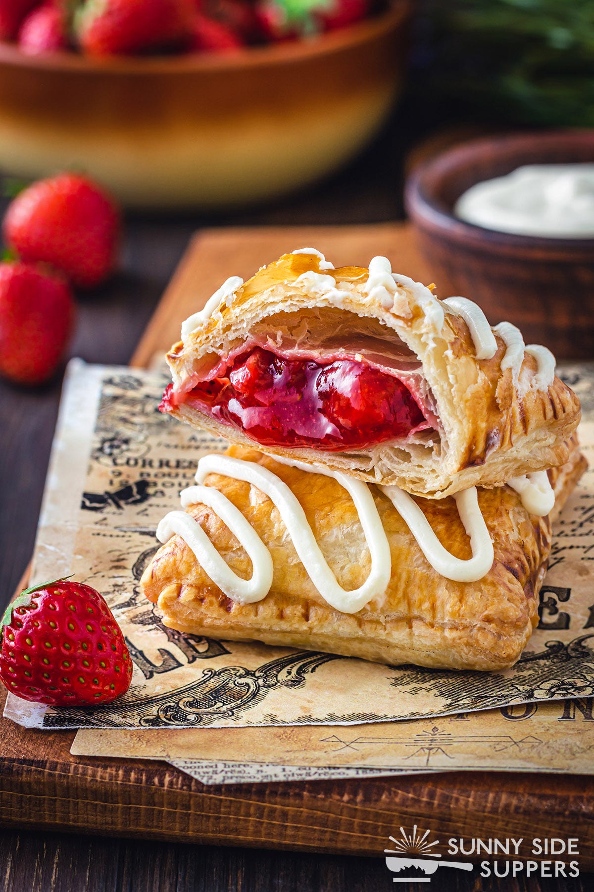 Two strawberry strudels, one cut in half.