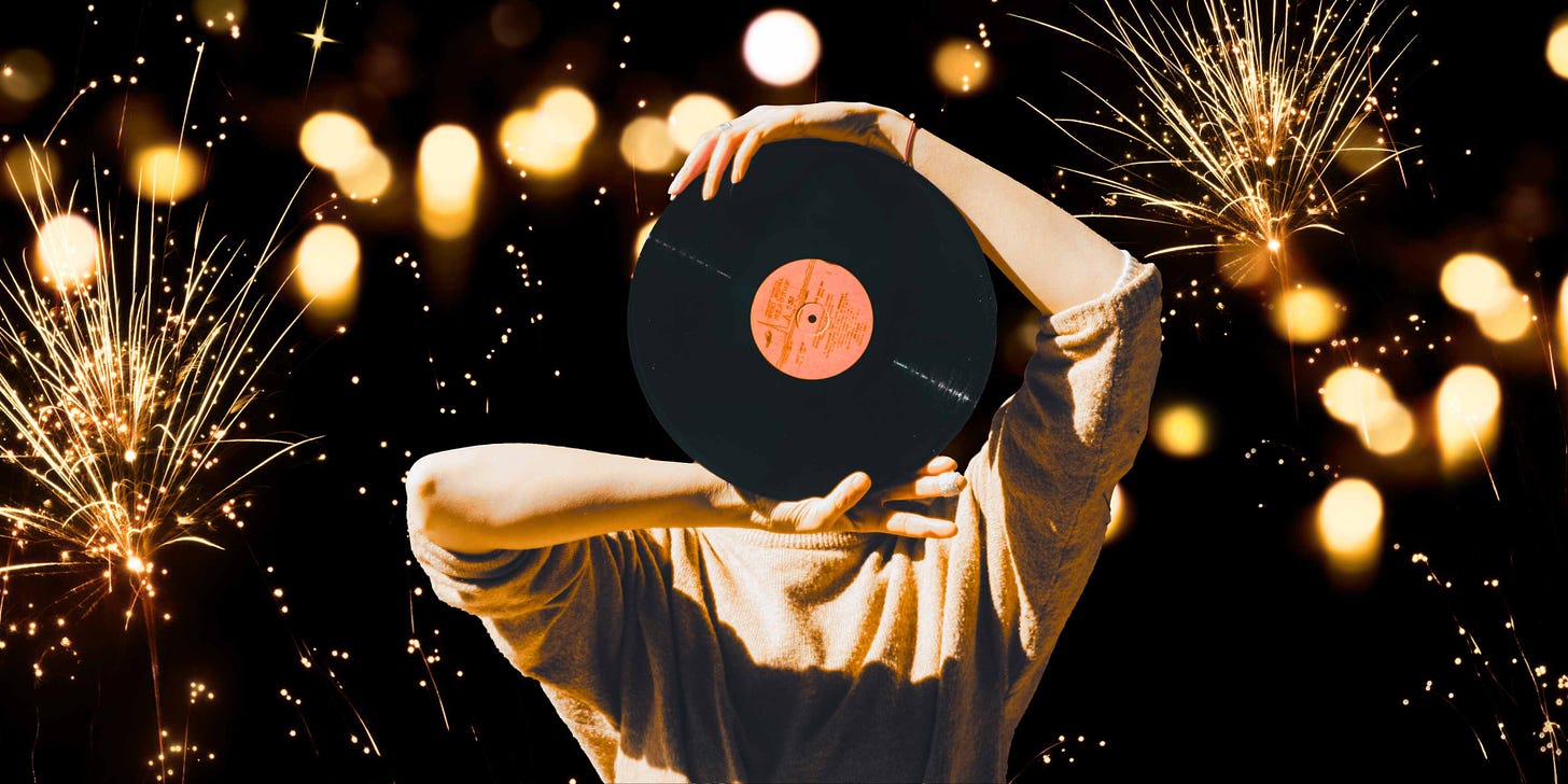 An image of yellow fireworks with a human holding a vinyl record up in front of their face