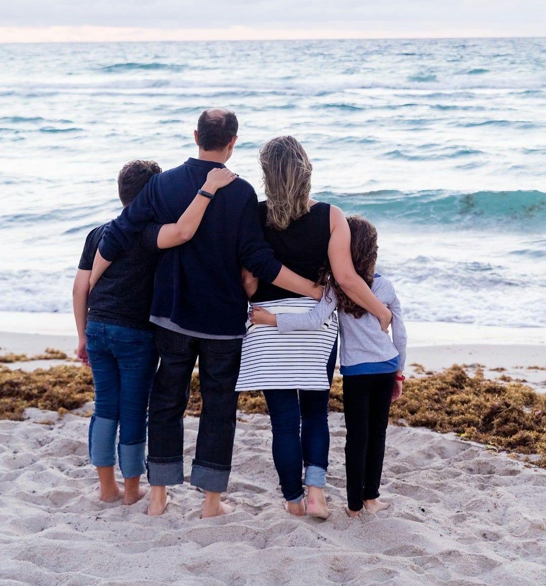 a family of four on a beach