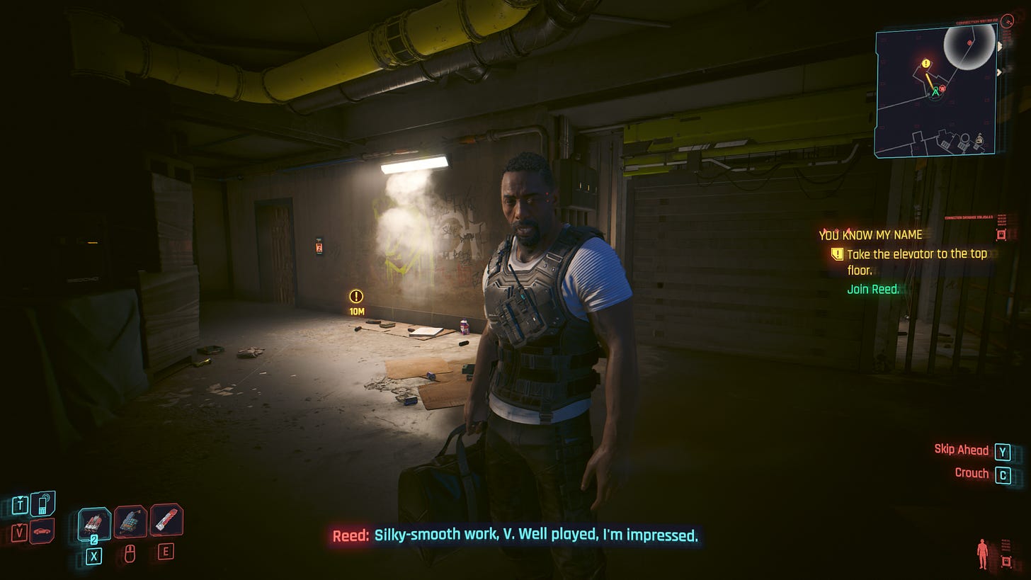 A screenshot of Cyberpunk 2077: Phantom Liberty, showing a dialogue scene in an old building with Solomon Reed, played by Idris Elba. The caption says: "Reed: Silky-smooth work, V. Well played, I'm impressed."
