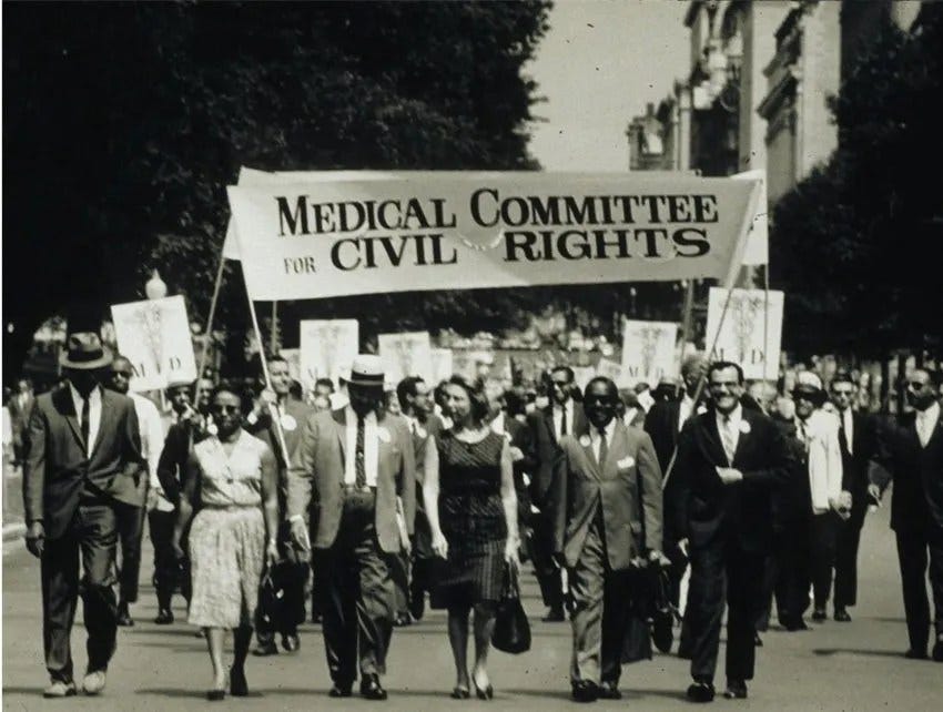 Civil rights protestors with Medical Committee banner