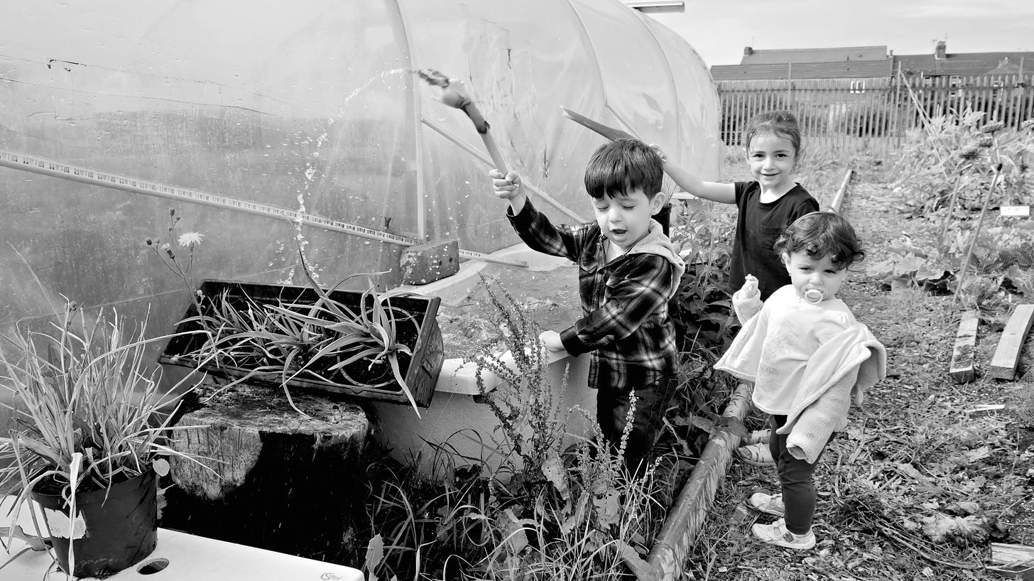 Children play with rainwater caught in a bathtub on an allotment, ‘Mini FEASTival West, Hull, 2018. © Jerome Whittingham
