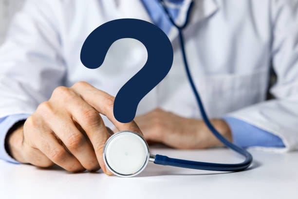 photo of a doctor with stethoscope and question mark. Symbolizes medical questions. 
