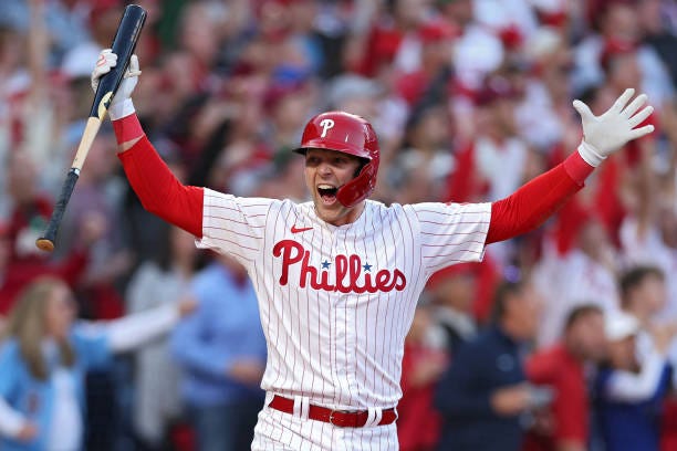 Rhys Hoskins of the Philadelphia Phillies celebrates by spiking his bat after hitting a three-run home run against Spencer Strider of the Atlanta...