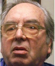 A person with glasses and a blue shirt

Description automatically generated