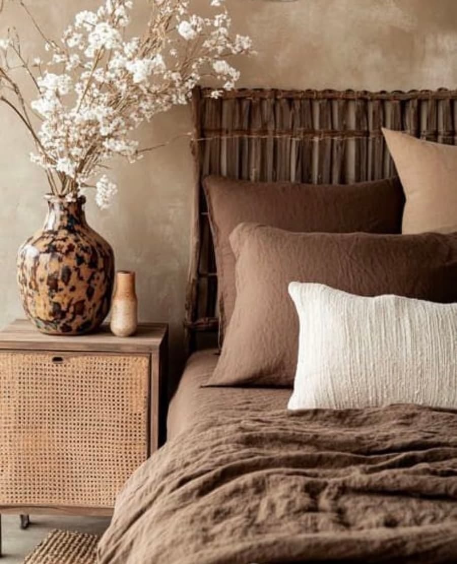 bed with brown and neutral pillows