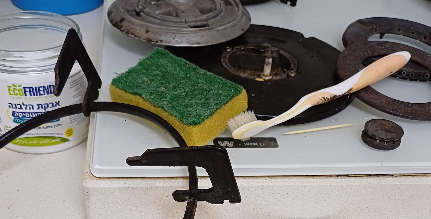 Photo of gas stove burner being cleaned