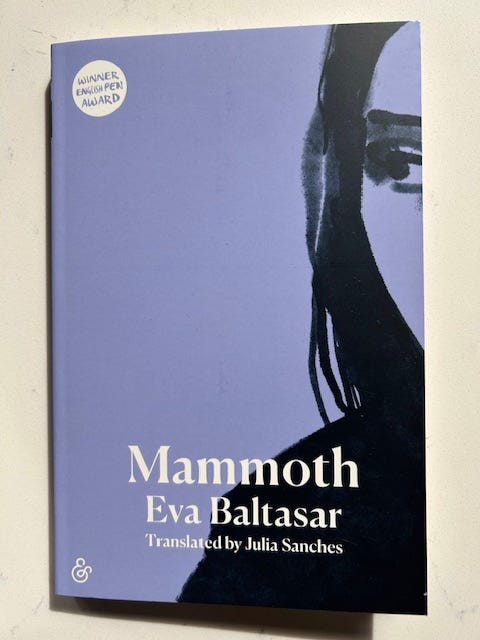 A lavender book cover with a drawing of a woman's profile on the right. Text reads Mammoth Eva Baltasar.