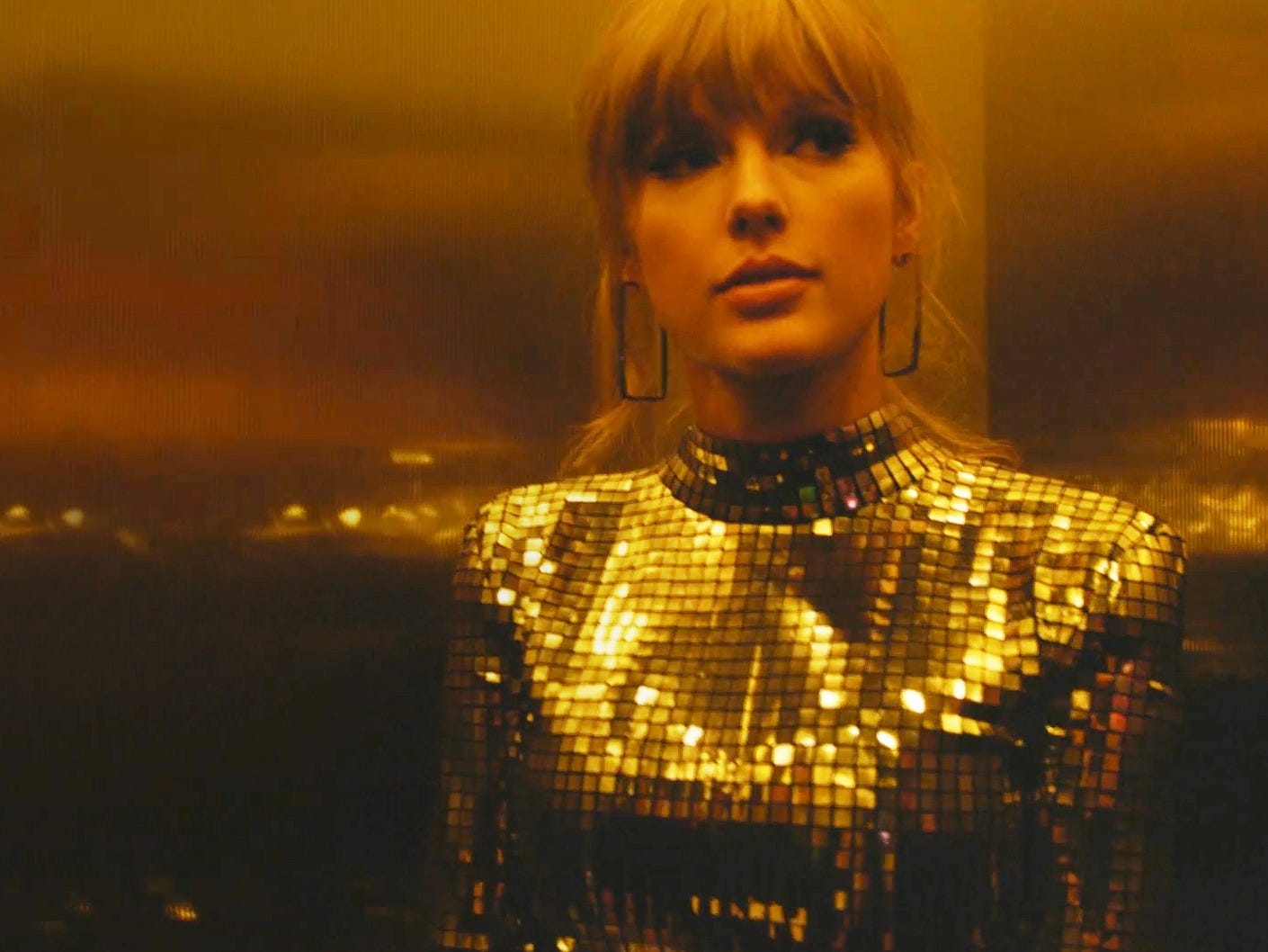 Taylor Swift in a gold dress