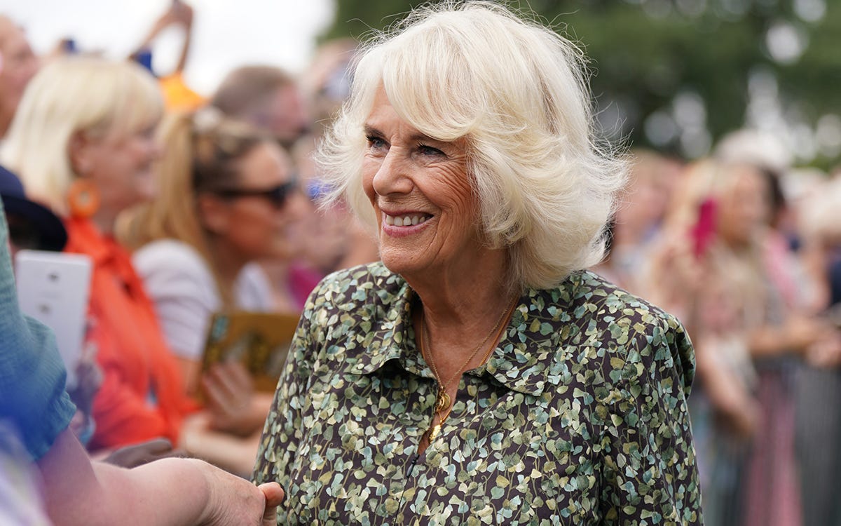 Queen Camilla wearing leaf print dress at Sandringham Flower Show