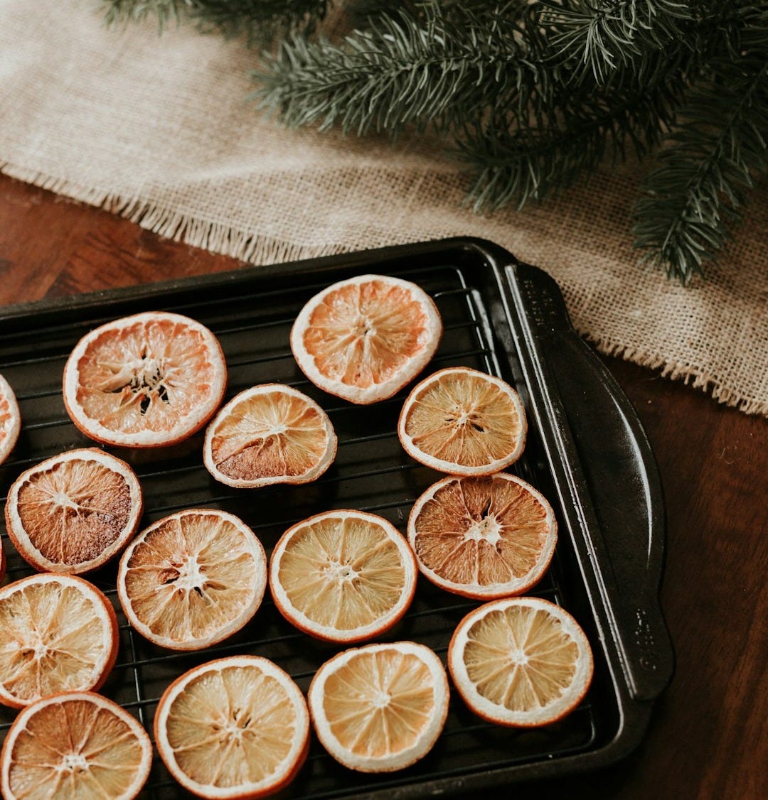 a tray of sliced oranges sitting on top of a wooden table